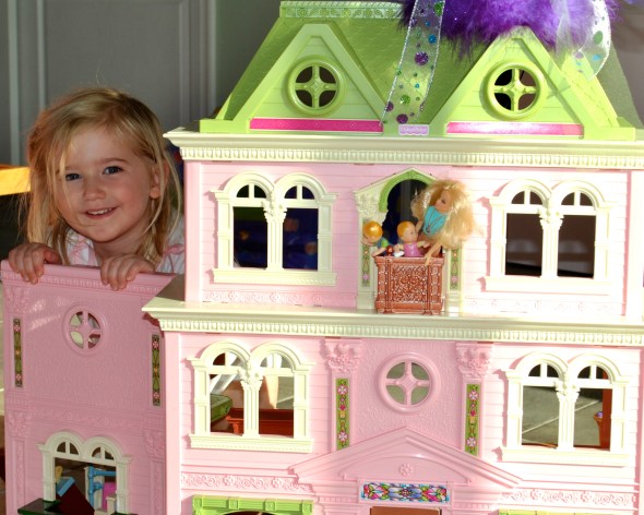 Lila with her dollhouse given by all her friends at her ECHOage party.